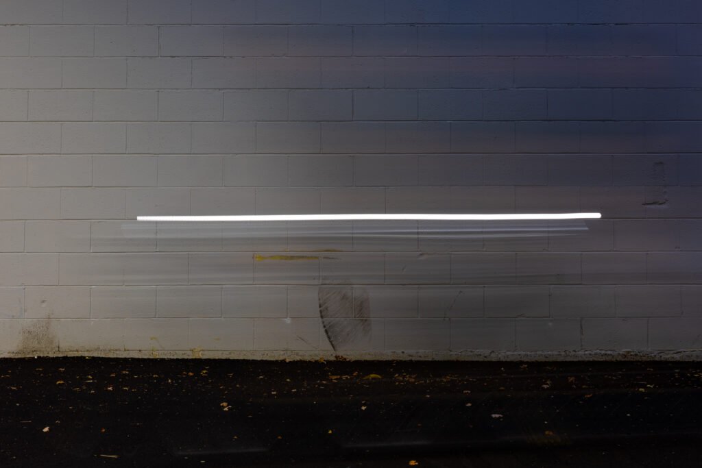 Self portrait on a bicycle early in the morning along a favorite wall